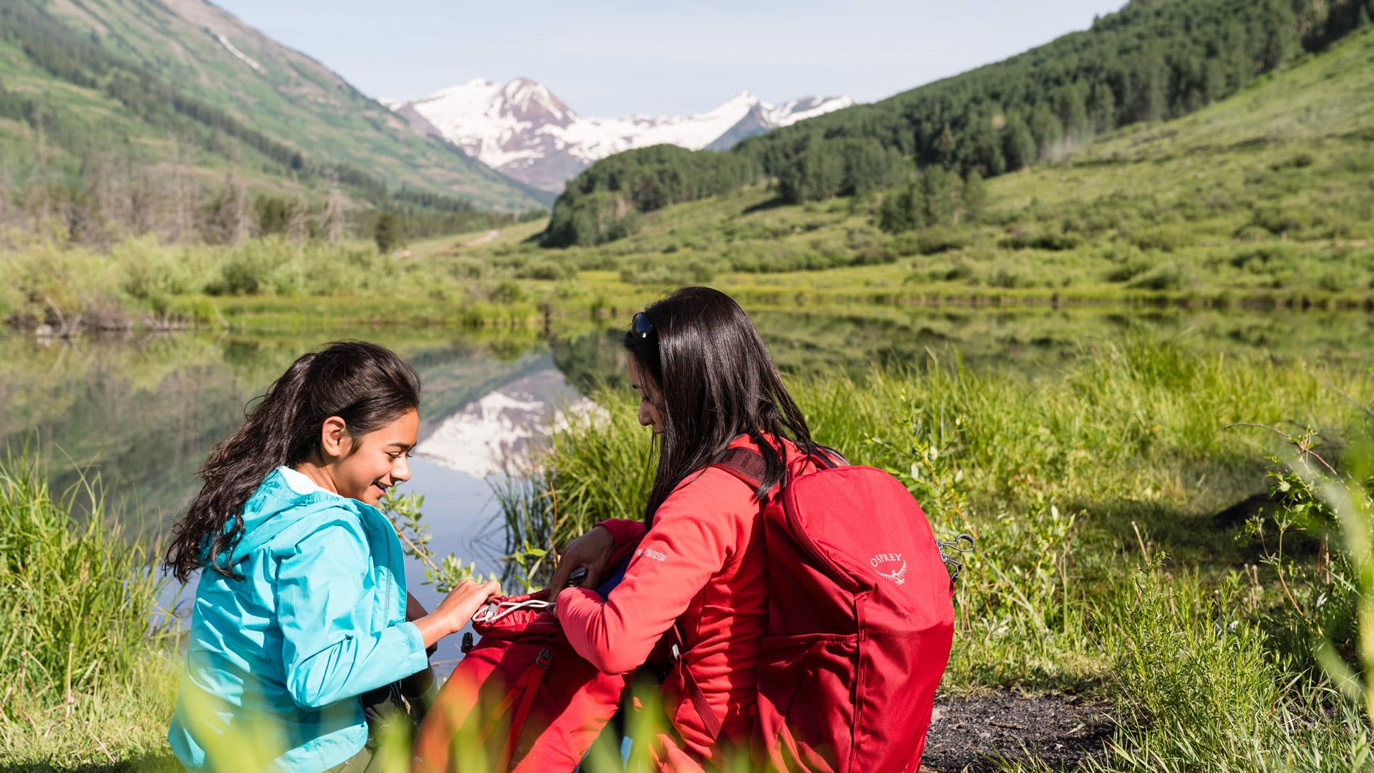 Two children exploring an alpine lake in Colorado