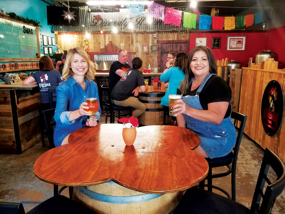 Two people drinking beer at Atrevida Beer Company in Colorado Springs