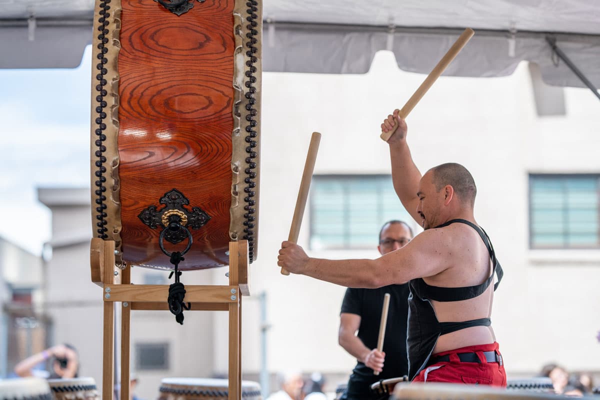 Taiko drummer performs, beating a massive raised drums with thick wooden sticks, at the Cherry Blossom Festival in Denver’s Sakura Square in Colorado.