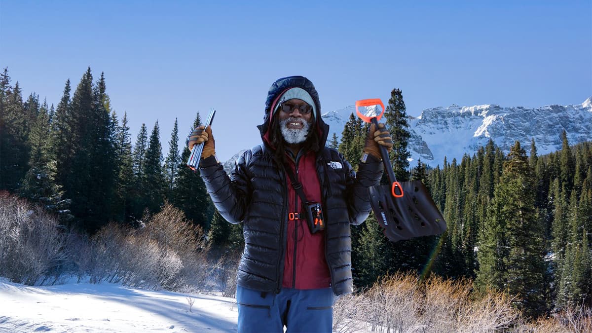 Person stands in snowy backcountry with avalanche rescue equipment
