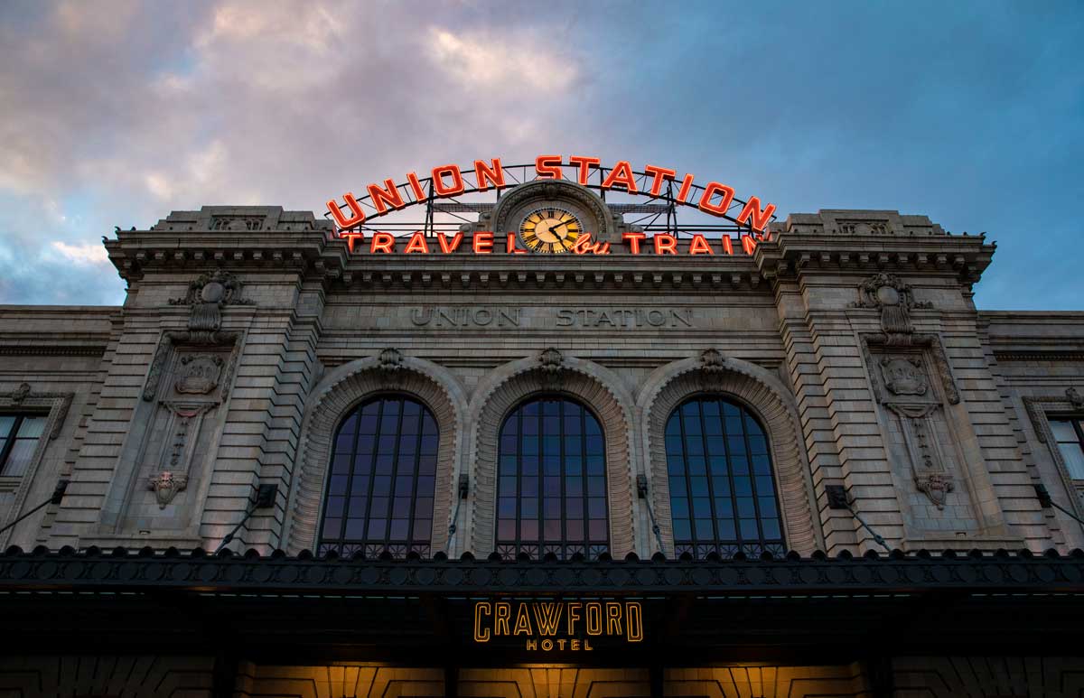 A few looking up at the entrance and massive windows ofUnion Station