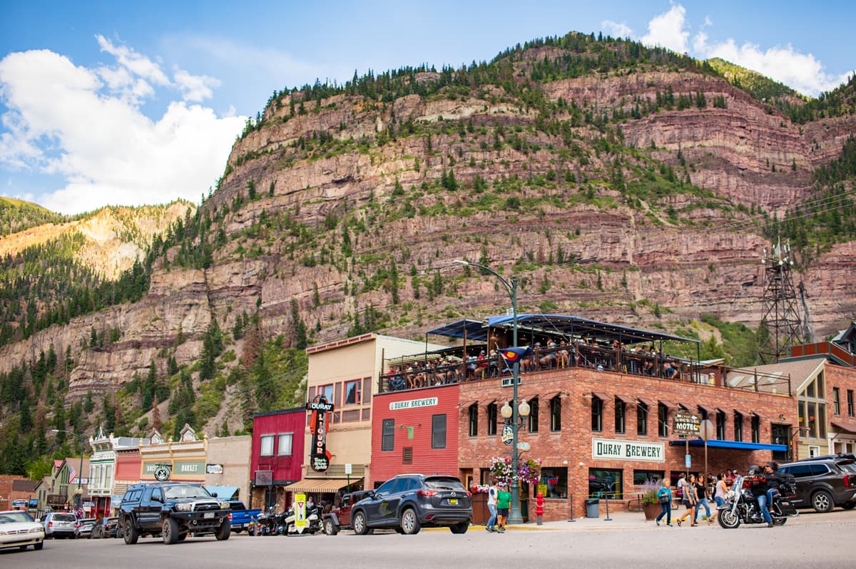 Historical Old-West buildings with canyon walls rising behind them in Ouray, Colorado