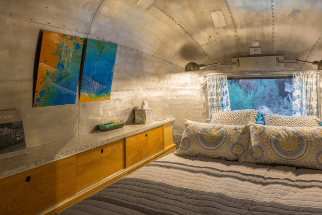 A cozy sleeping nook within Canyon Hideout Bungalow Airstream