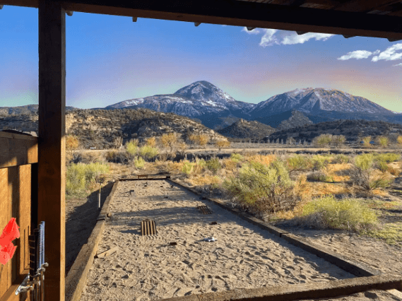 Grassy desert landscape seen from Canyon Hideout Bungalo's pergola