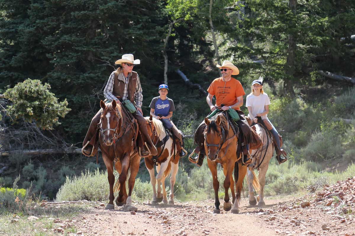 Black Mountain Ranch guests ride horses with a guide