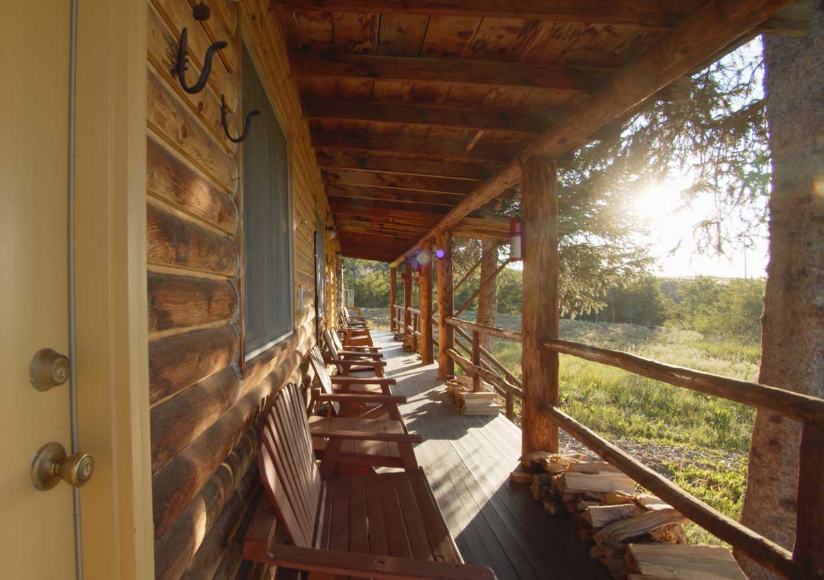 Sun shines through the trees and onto a shaded deck at Latigo Ranch
