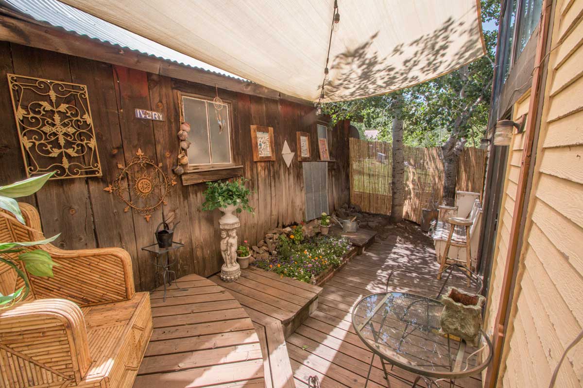 Rico Mine Shaft Inn's outdoor garden area complete with sunshade and rustic decor