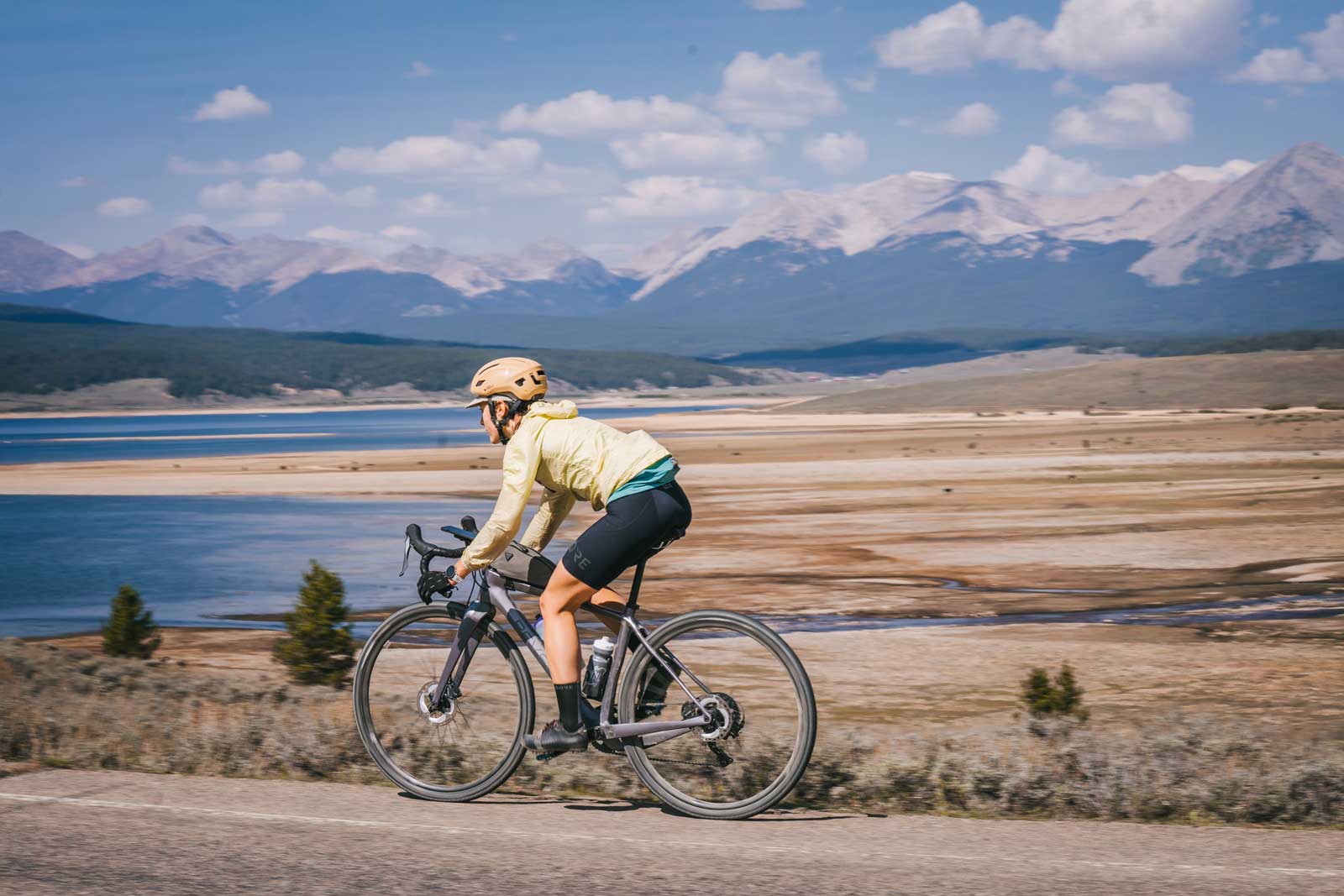 A gravel biker rides toward Taylor Reservoir near Crested Butte
