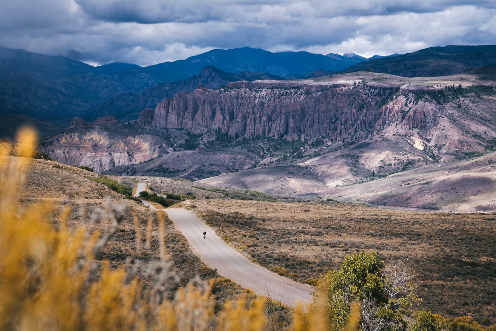 The scale of surrounding peaks make a gravel biker look like a tiny ant