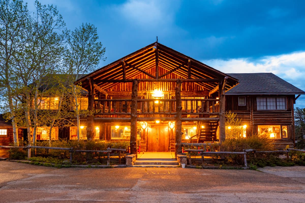 As dusk falls, the Meeker Park Lodge is set aglow with warm lights the beckon weary adventurers near Allenspark, Colorado.