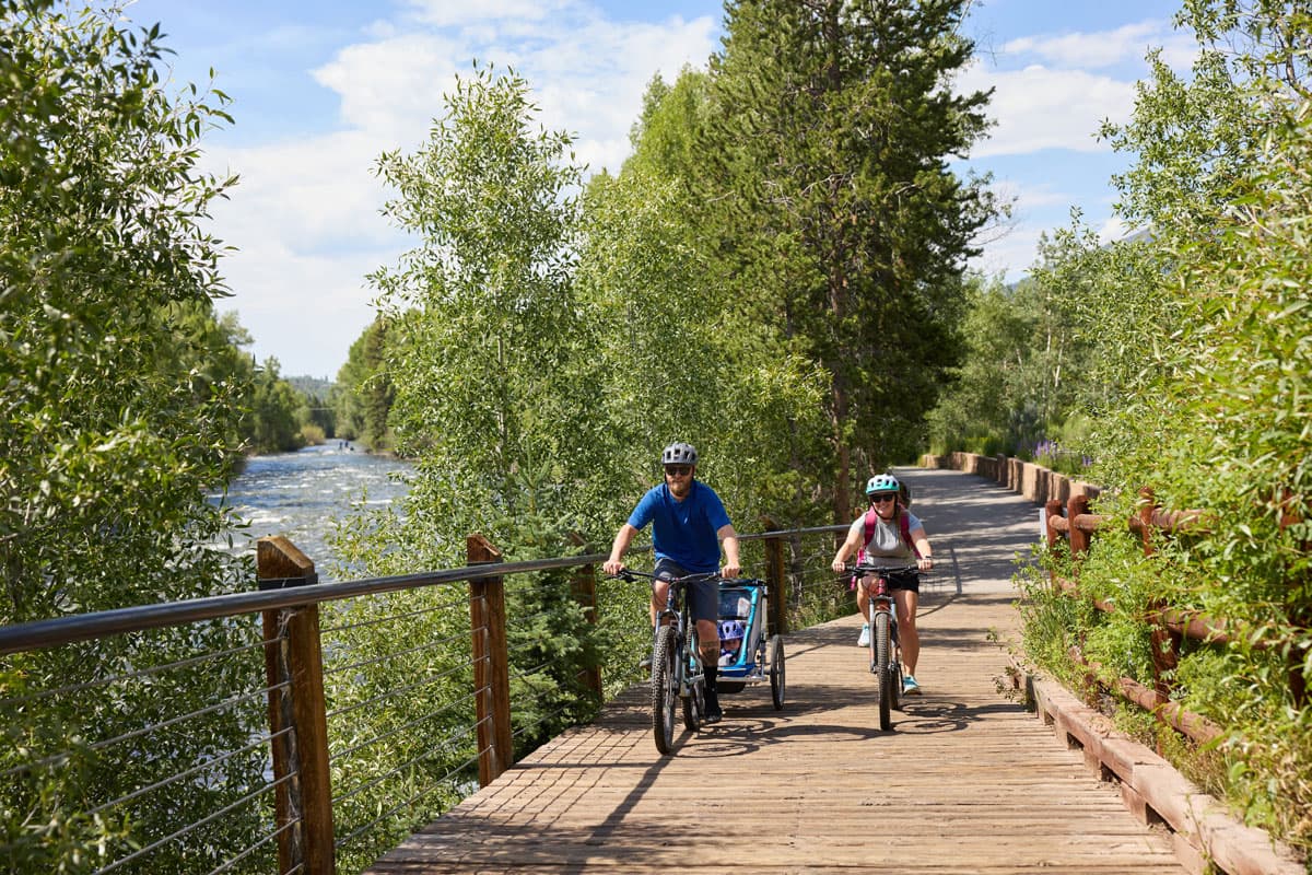 Biking alongside peaceful waters and lush trees at Silverthorne Colorado