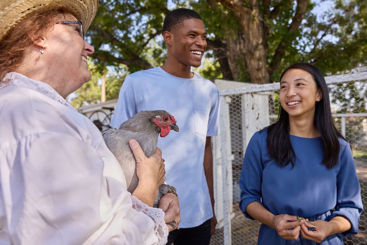 Guests engaging with farm animals at Centennial Village Museum in Greeley, Colorado.