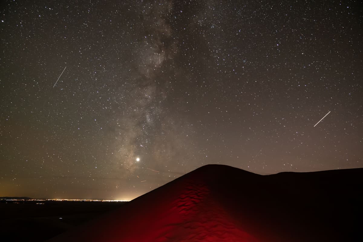 The Milky Way and other stars brighten the night sky above Great Sand Dunes National Park and Preserve in Alamosa Coloraod