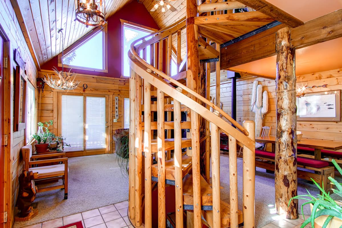 A knotty, wooden spiral staircase sits in the heart of this rental in Dillon, Colorado.