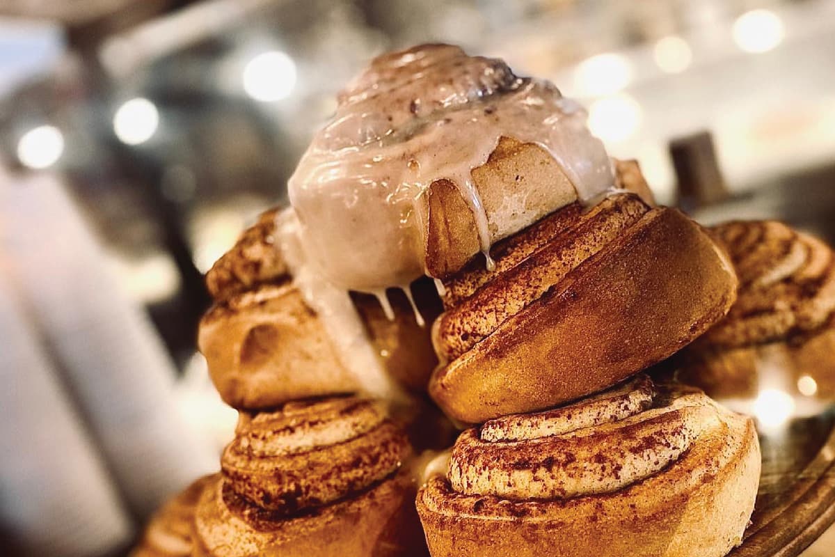 Glazed cinnamon rolls stacked at Muddy Buck Coffee House