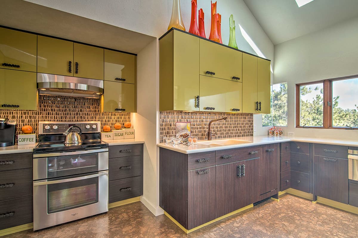 Olive-green cabinets, rock-style handles and unique artwork give the Barret House near Boulder, Colorado, a vintage vibe.