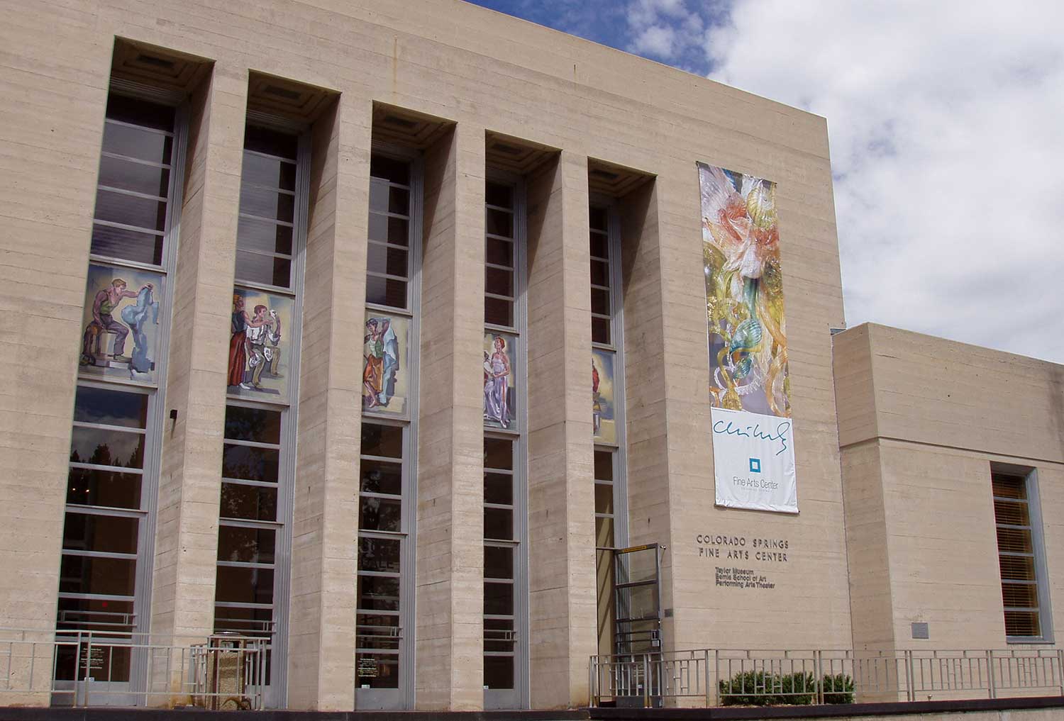 Exterior of Colorado Springs Fine Arts Center with exhibit signs on a cloudy day