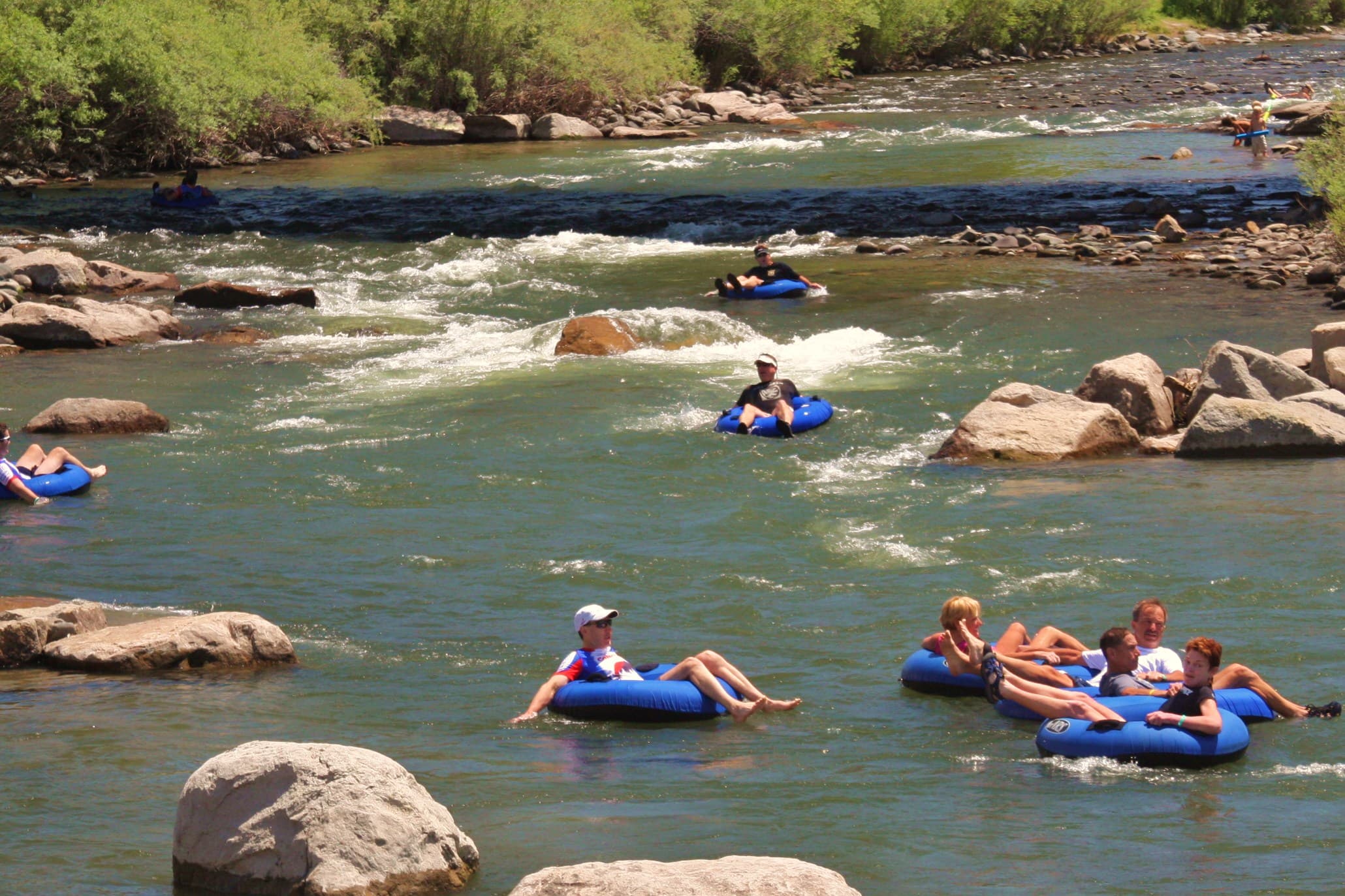 People float on tubes on a slow-moving river in Pagosa Springs