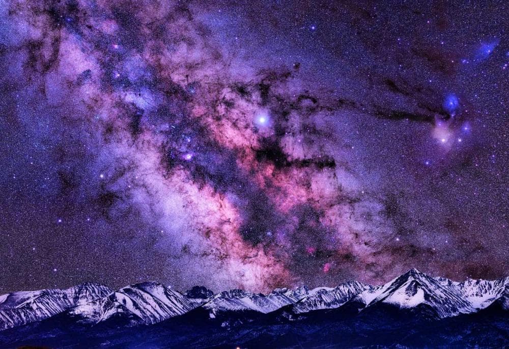 A purple clouded sky is above snow-covered Westcliffe's Wet Mountains courtesy of Lars Leber