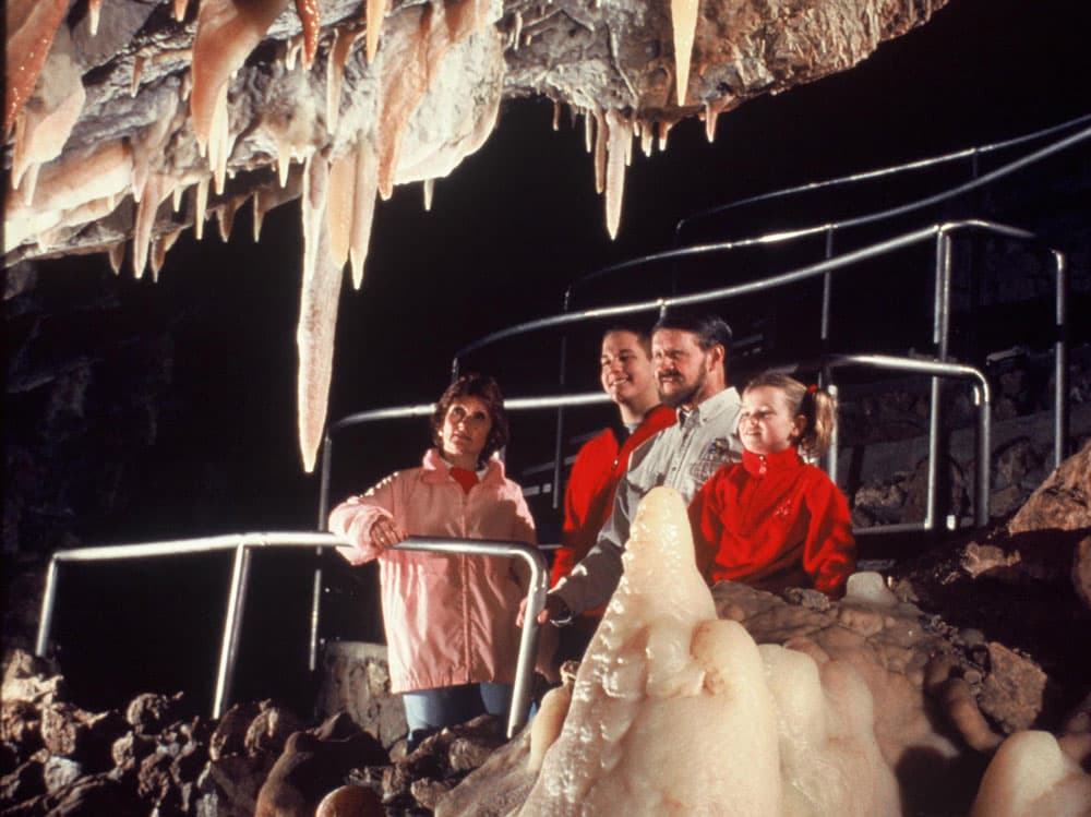 Four people gaze at rock formations inside Glenwood Caverns in Glenwood Springs, CO