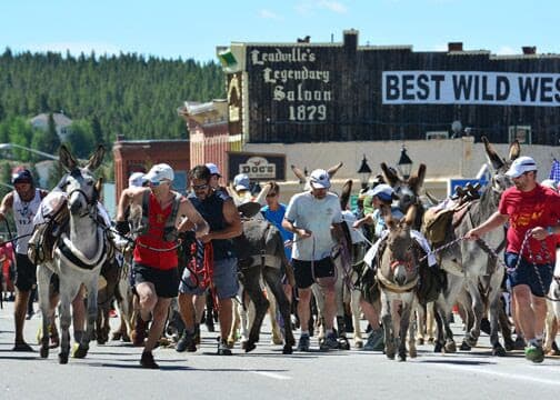 Contestants running down the roads in the Leadville Boom Days burro race