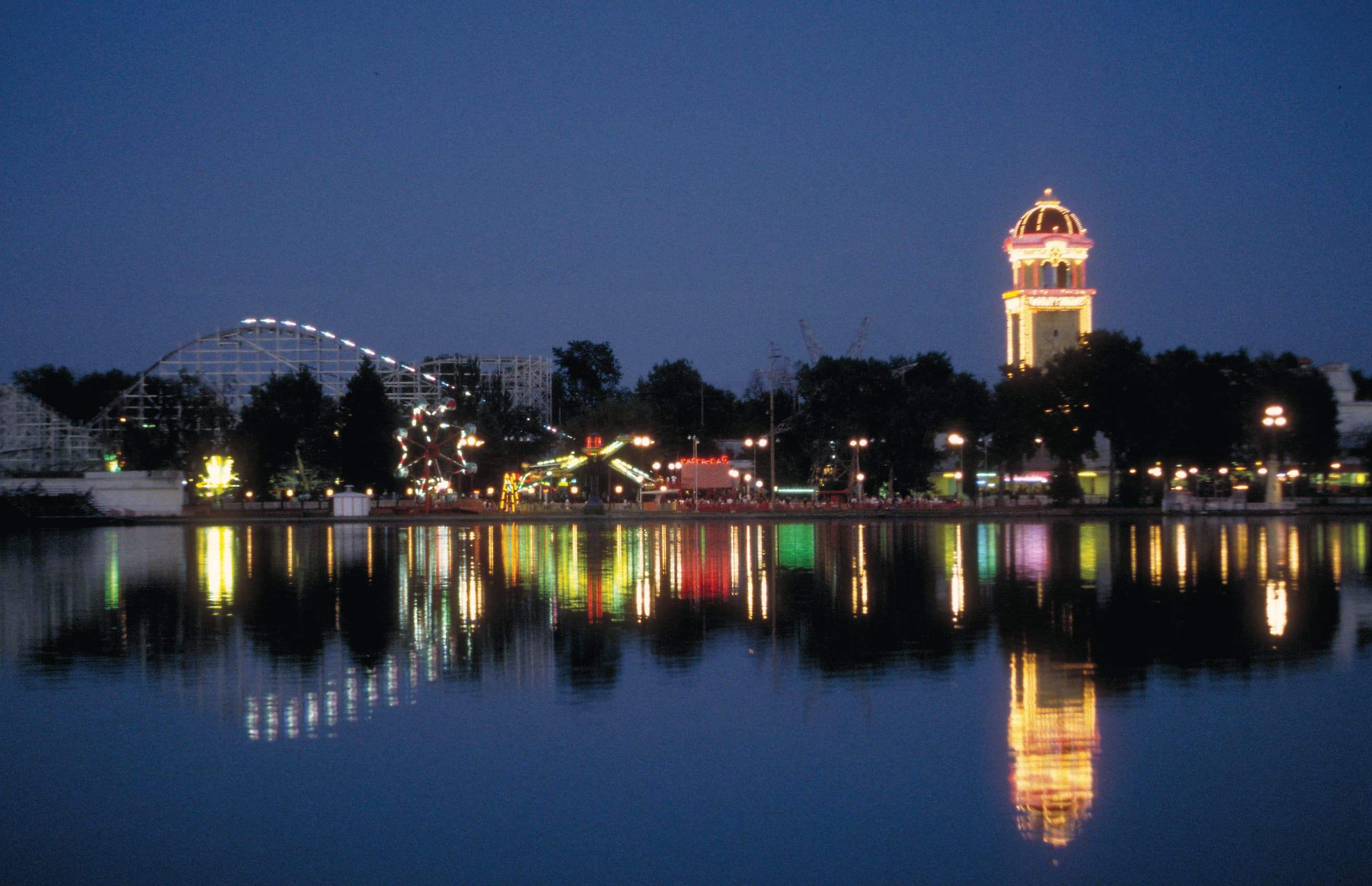 lakeside amusement park across lake at night photo