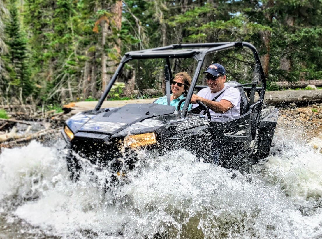 couple crashing through water hole in a razor on our atv trail photo 6