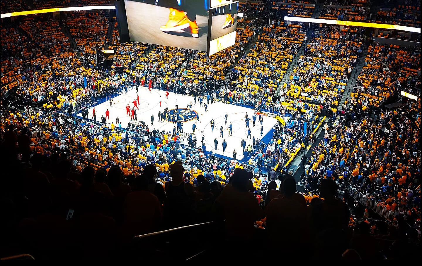 Basketball players warm up for a game at Ball Arena