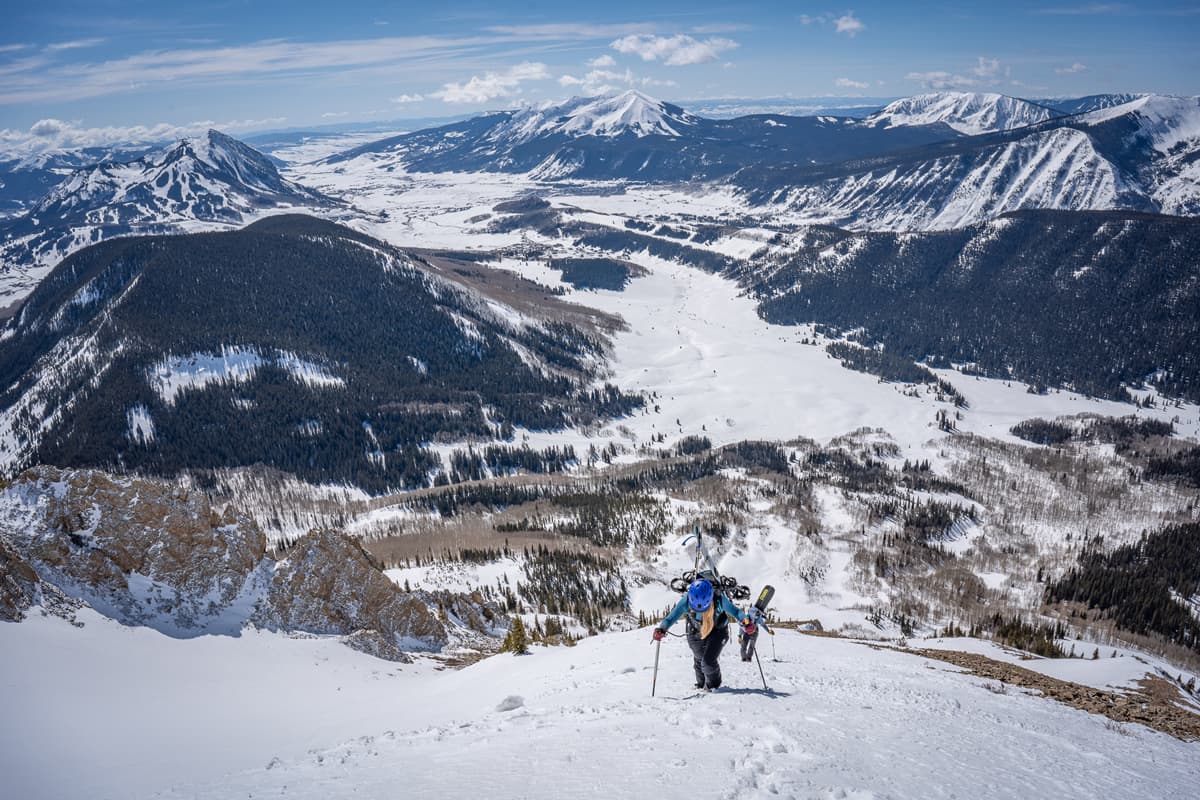 A person uphill skis in the mountains of Gunnison County in Colorado