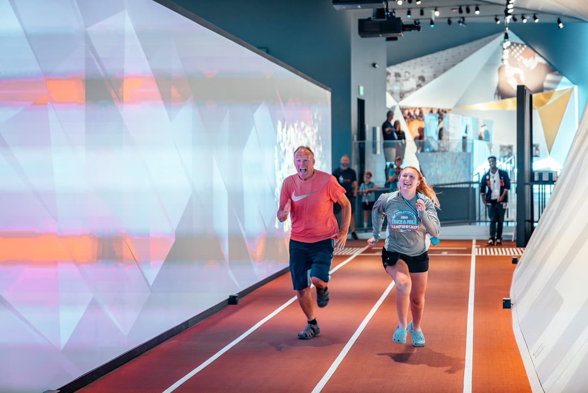 Dad and daughter racing on track at the U.S. Olympic & Paralympic Museum in Colorado Springs