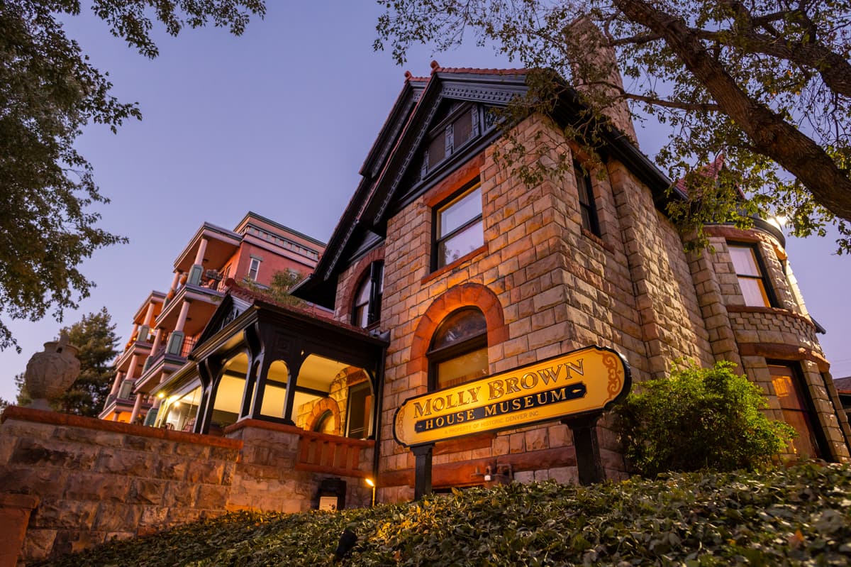 Exterior of the Molly Brown House Museum in Denver, a historic stone home associated with the Unsinkable Molly Brown, photographed at dusk.