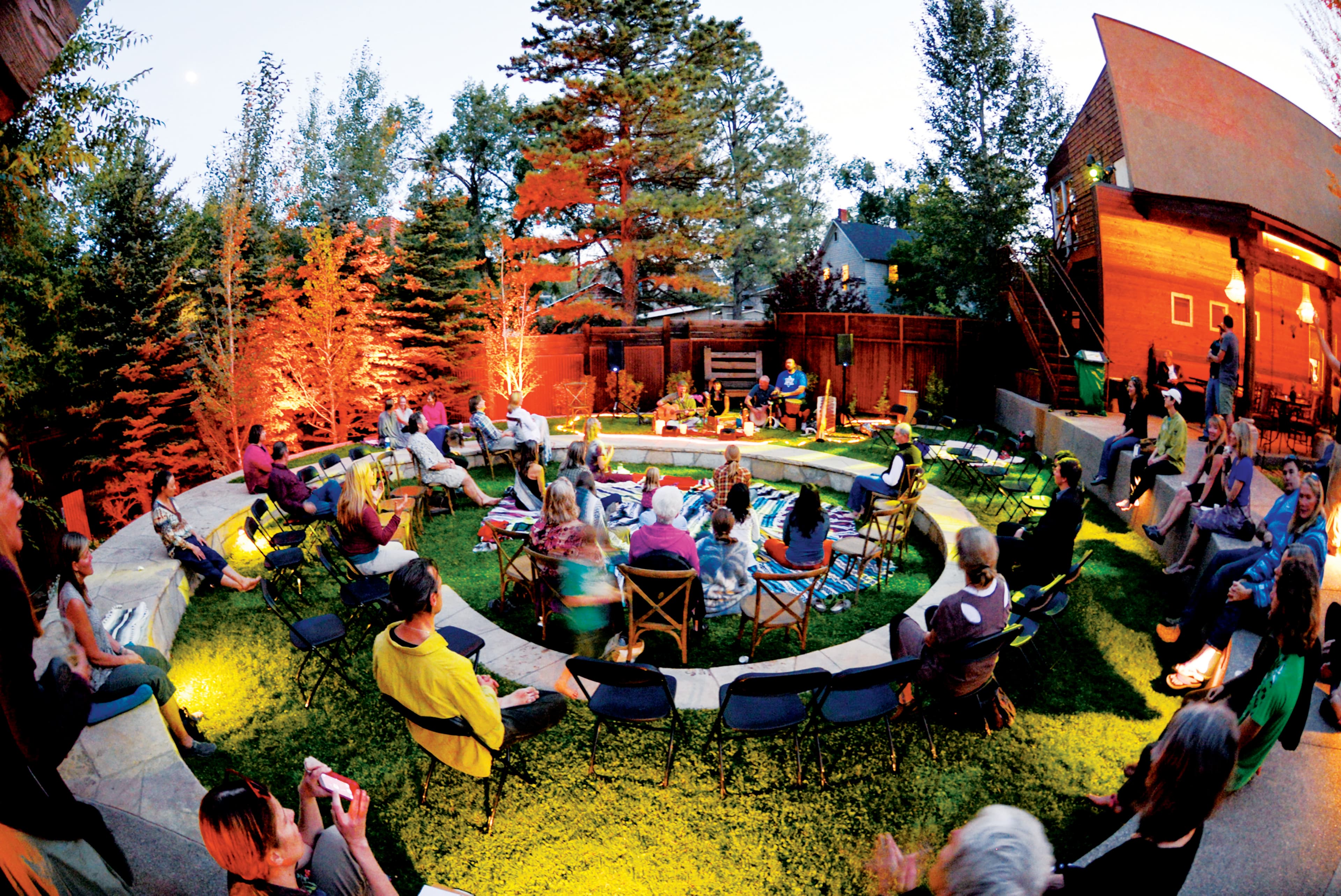People sit on camping chairs and watch a music performance in the Carbondale Creative District