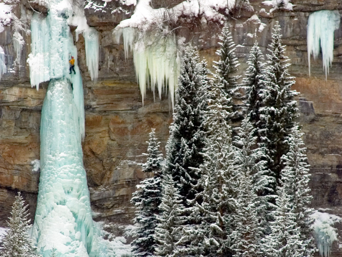 A climber scales a frozen waterfall near Vail.