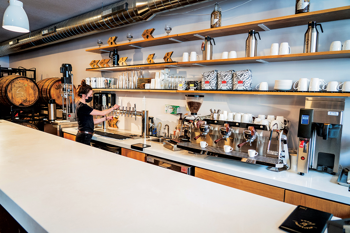 A barista makes a drink inside a coffee shop