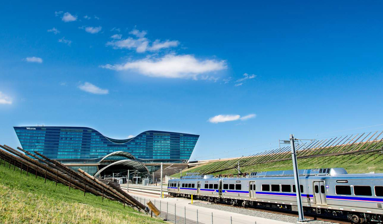 A train pulls up to the airport's hotel