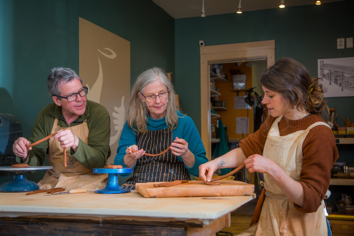 Members of the San Juan Potters' Guild in Ouray working with bands of clay