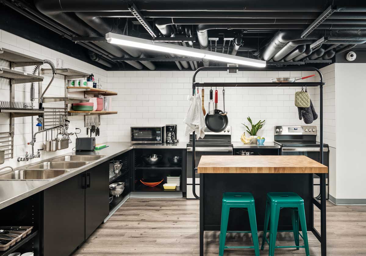 The shared guest kitchen at The Pad in Silverthorne is both stylish and functional; check out the bright-green stools at the center island. 