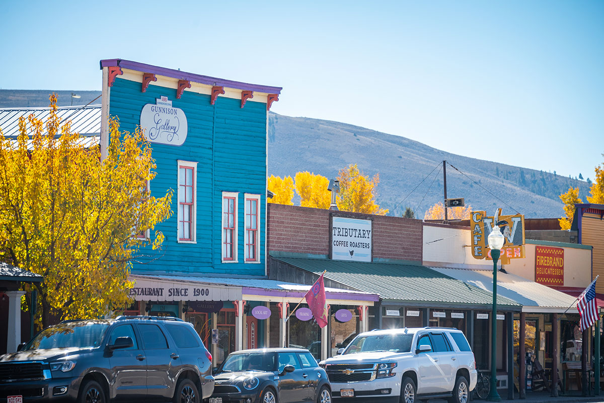 Charming coffee shop building and Main Street surrounded by golden aspen trees in fall