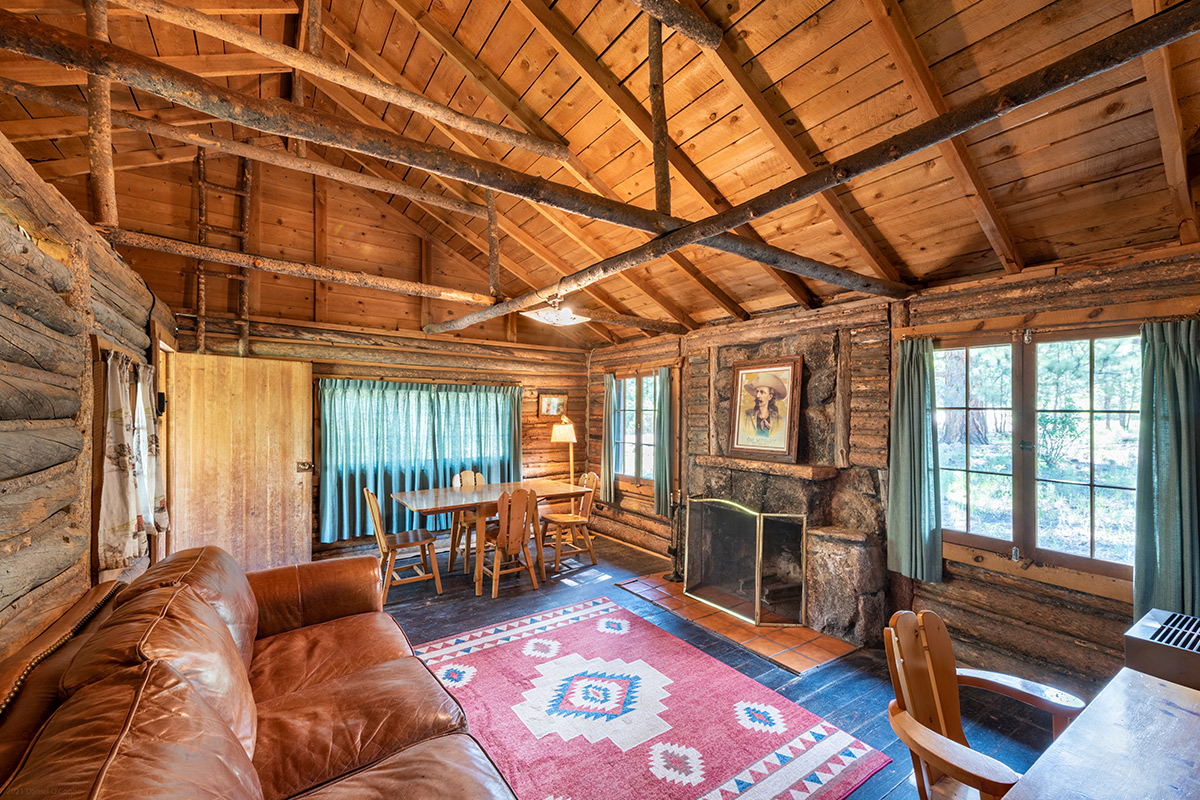The inside of a cabin at Meeker Park Lodge, is filled with Western charm and woodsy touches, like hand-hewn beams.