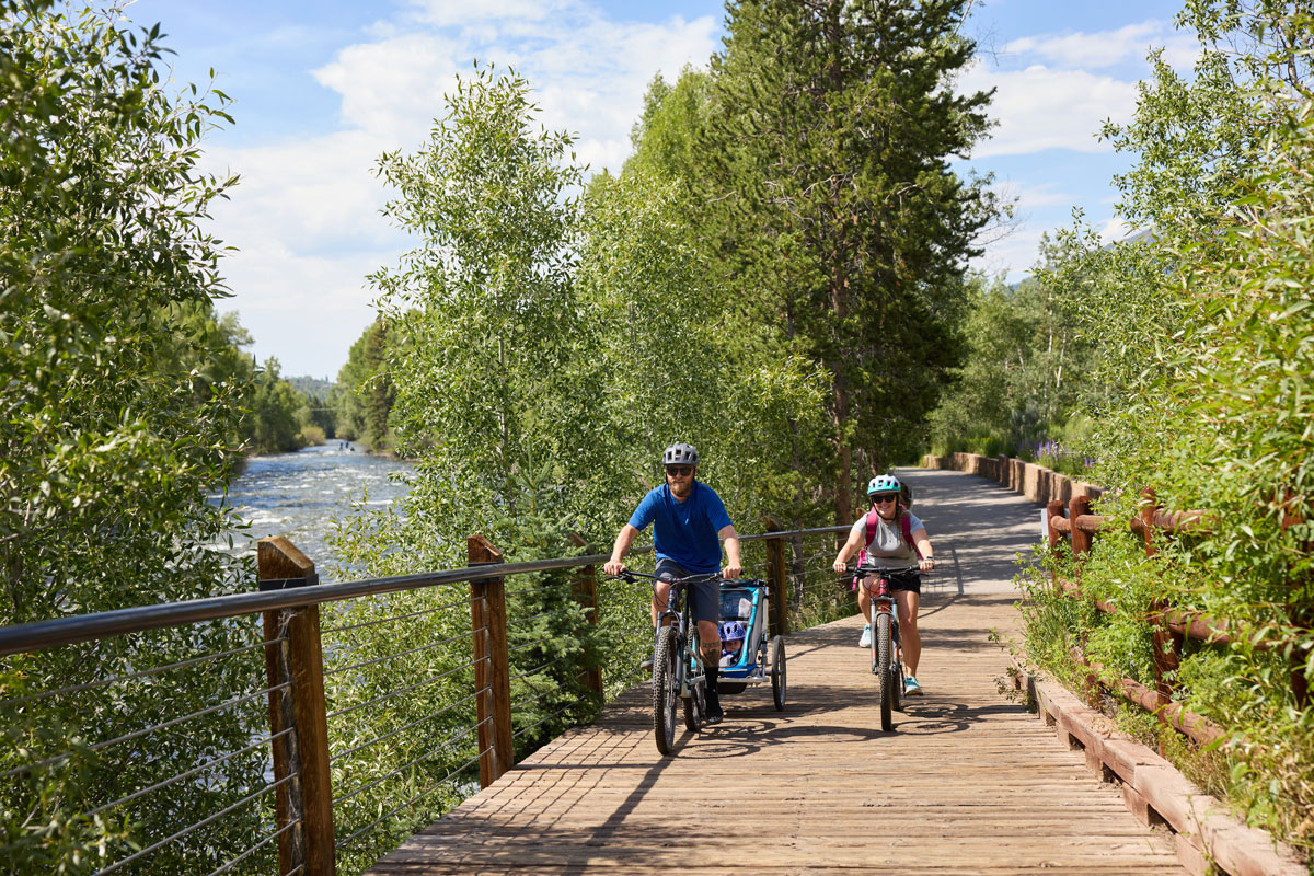 Biking alongside peaceful waters and lush trees at Silverthorne Colorado