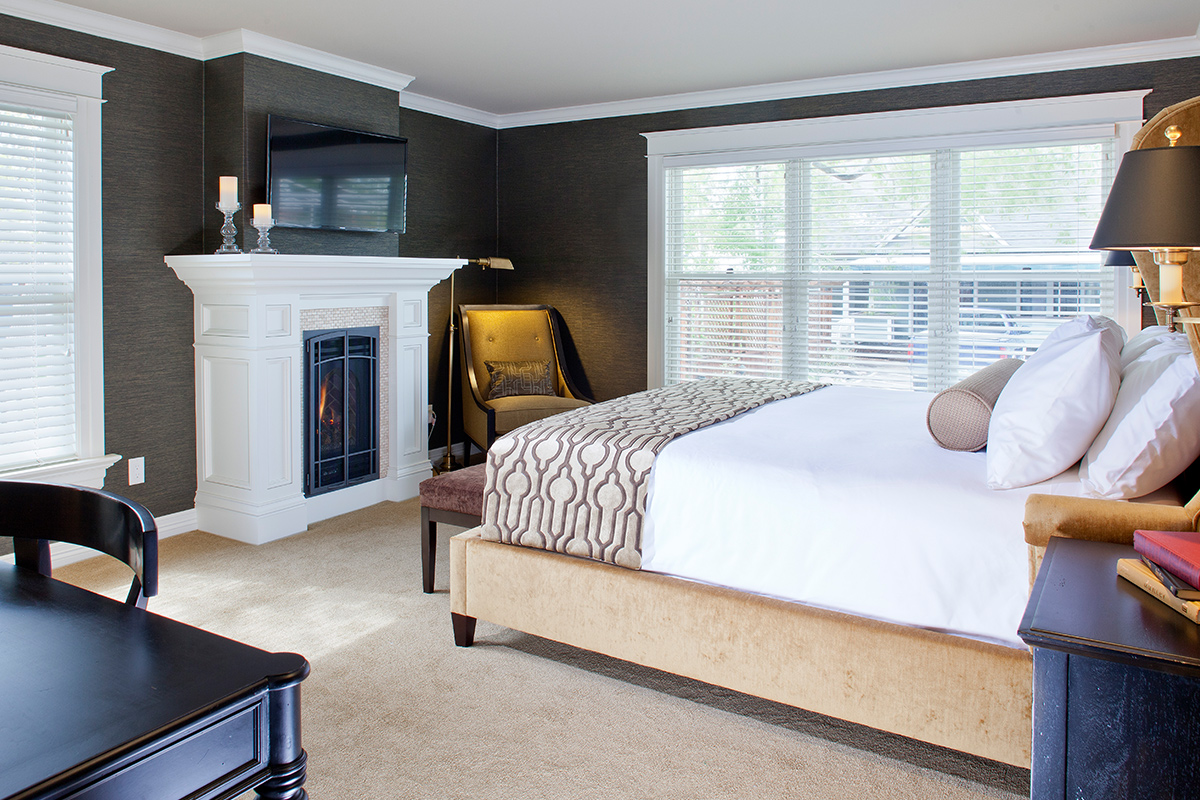 The Meldrum Room at Edwards House is lit with natural light and decorated with an elegant fireplace and cozy furnishings.