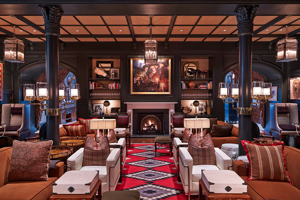 In Aspen, Colorado, a common area of the Hotel Jerome is lavishly decorated with historical pieces, lit candles and rich leather couches.