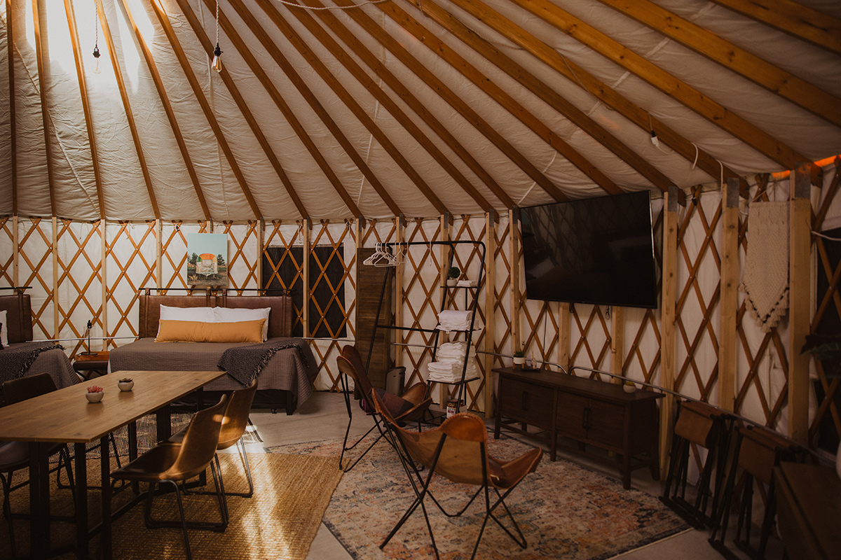A yurt at Trail and Hitch near Meeker, Colorado, is outfitted with modern amenities, including a TV, two plush beds and plenty of sitting space.