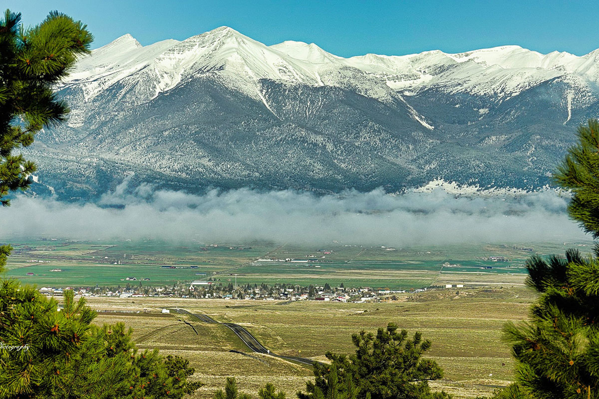 Low lying clouds hover over the Wet Mountain Valley floor near Westcliffe, Colorado.