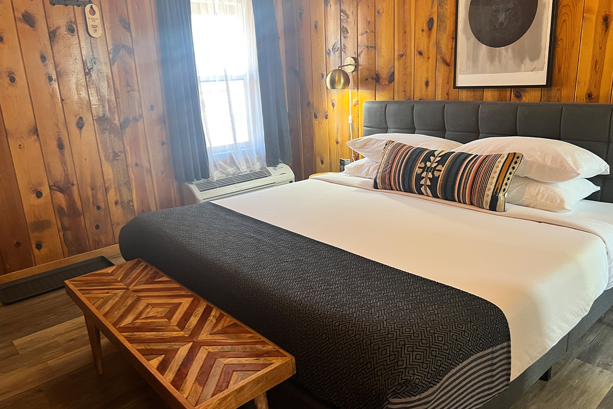 Stay in a wood-paneled, cabin-style guest room at The Nightingale Hotel in Pagosa Springs, CO.
