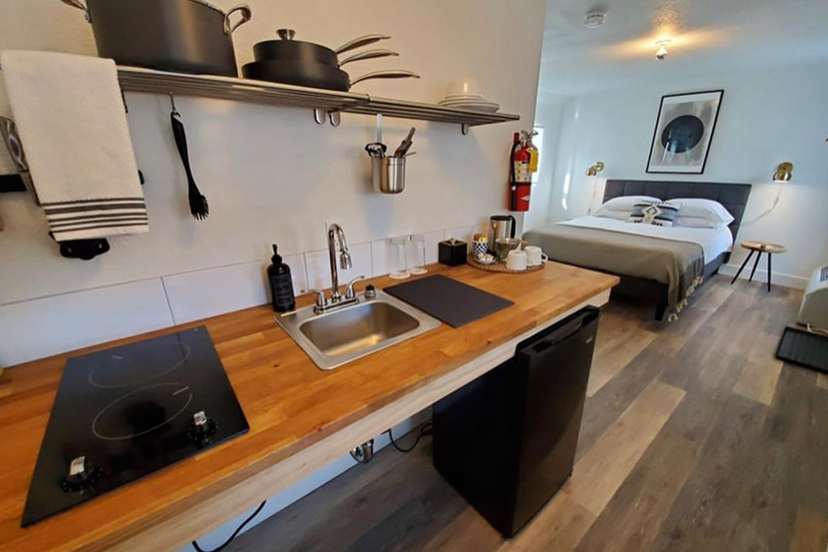 A guest room at Pagosa Springs' Nightingale Hotel features a kitchenette with cooking utensils and an electric stove.