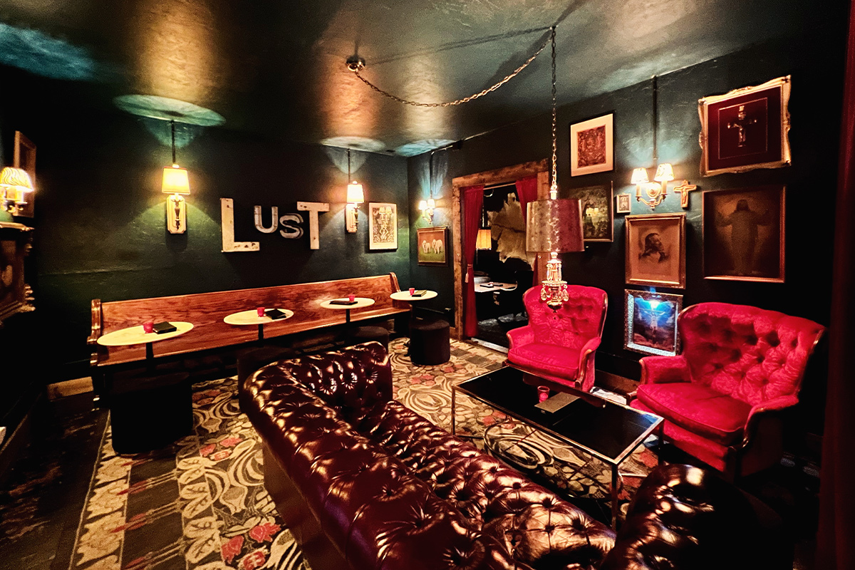 The Neon Mallard Cocktail Lounge in Pagosa Springs, CO, features an eclectic mix of patterned rugs, velvet arm chairs, leather sofas and walls lined with photos and art.