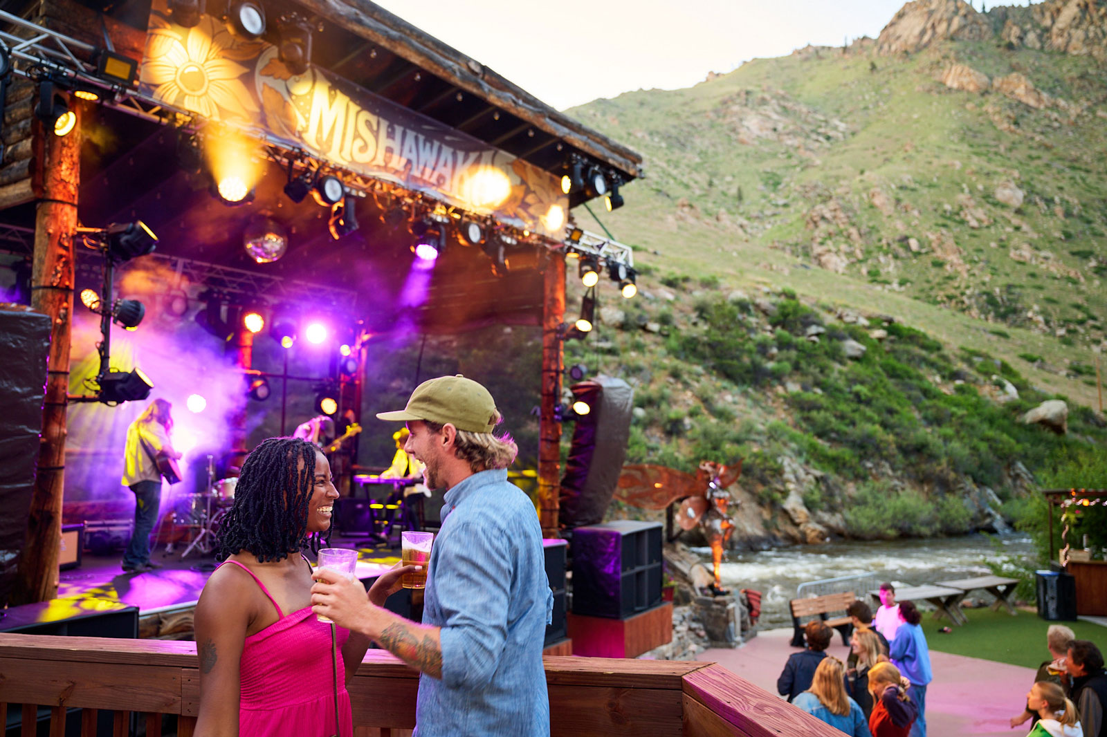 Two people talk near the stage that the outdoor Mishawaka amphitheatre