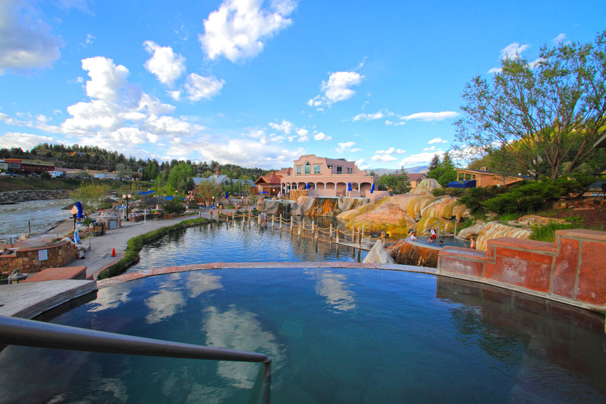 Blue skies over a still hot springs pool in Pagosa Springs