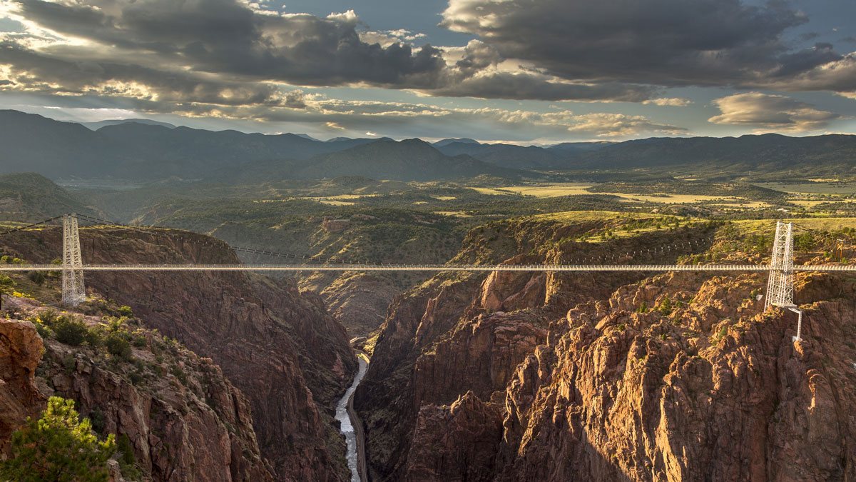 Suspension bridge stretching across the Royal Gorge above a steep canyon and river below in Colorado